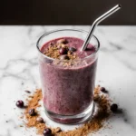 Prizmatem Smoothie in clear glass with cinnamon and berries