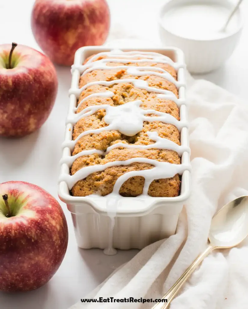 Apple Cinnamon Bread loaf sliced on white marble