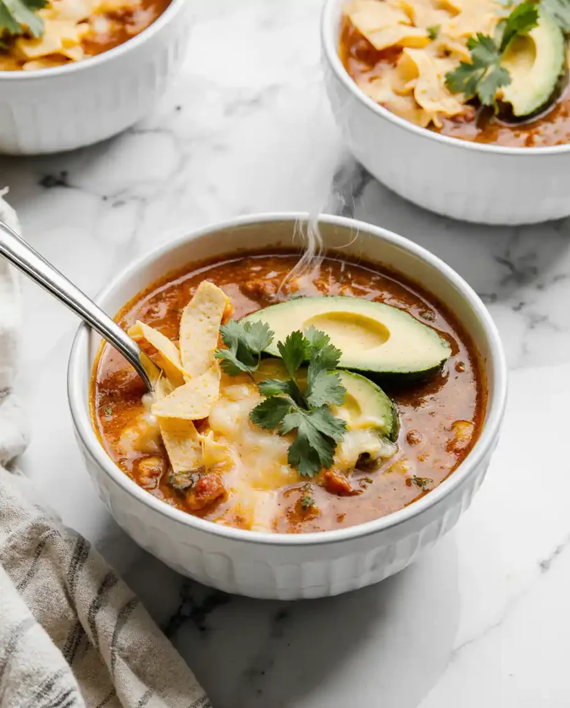 Bowl of cheesy taco soup with toppings