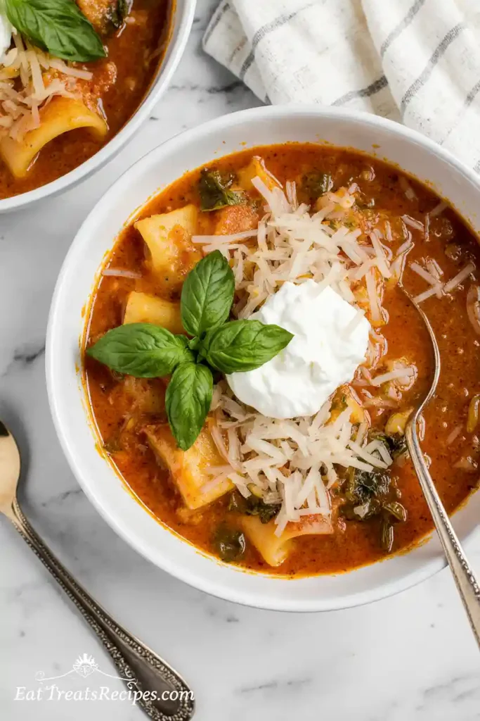 Bowl of lasagna soup topped with ricotta and basil