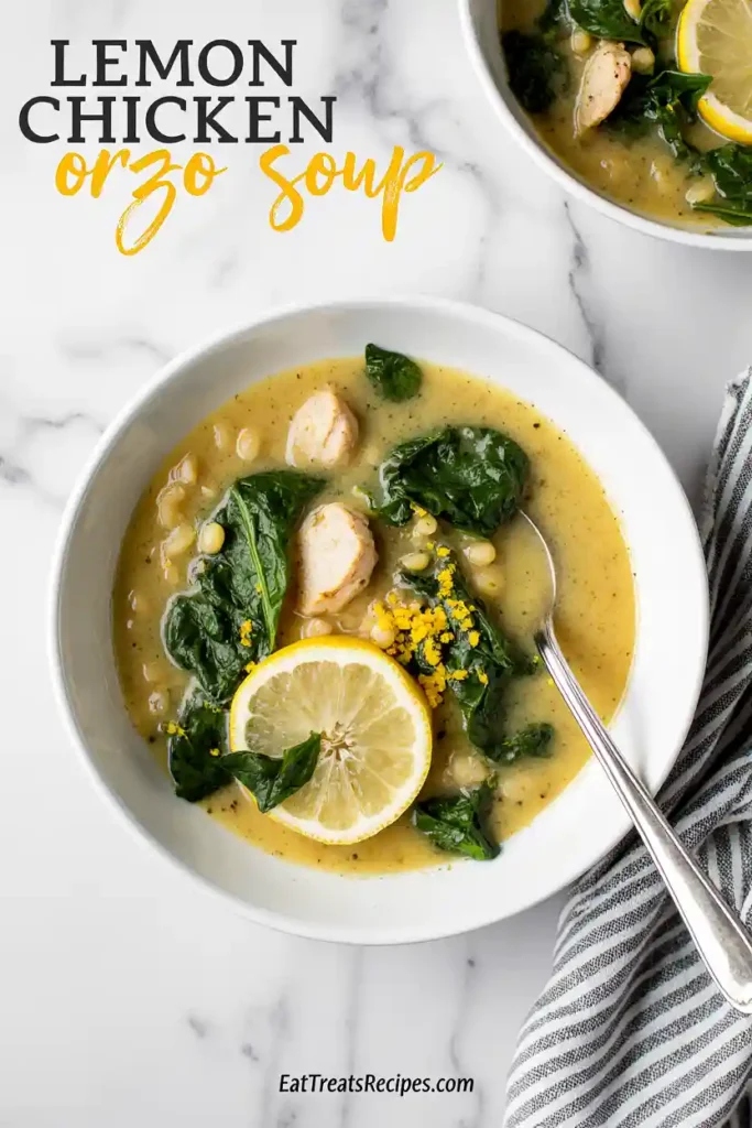 Bowl of lemon chicken orzo soup topped with spinach and lemon zest
