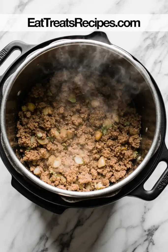 Ground turkey with onion and garlic cooking in pot