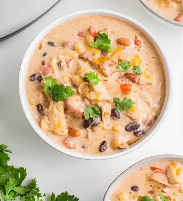 Slow-Cooker Cream Cheese Crack Chicken in bowl on white marble