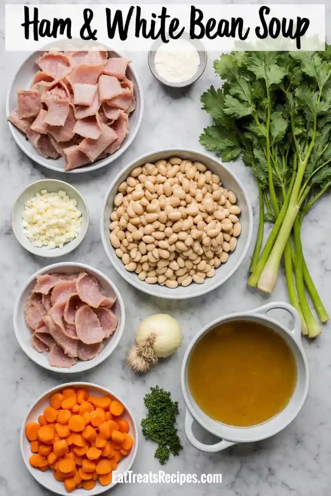 Ingredients for ham and white bean soup arranged on marble surface