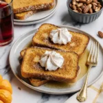 fall pumpkin french toast for breakfast with whipped cream and maple syrup
