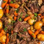 tender beef roast slow cooker dinner with carrots, potatoes, and rich gravy