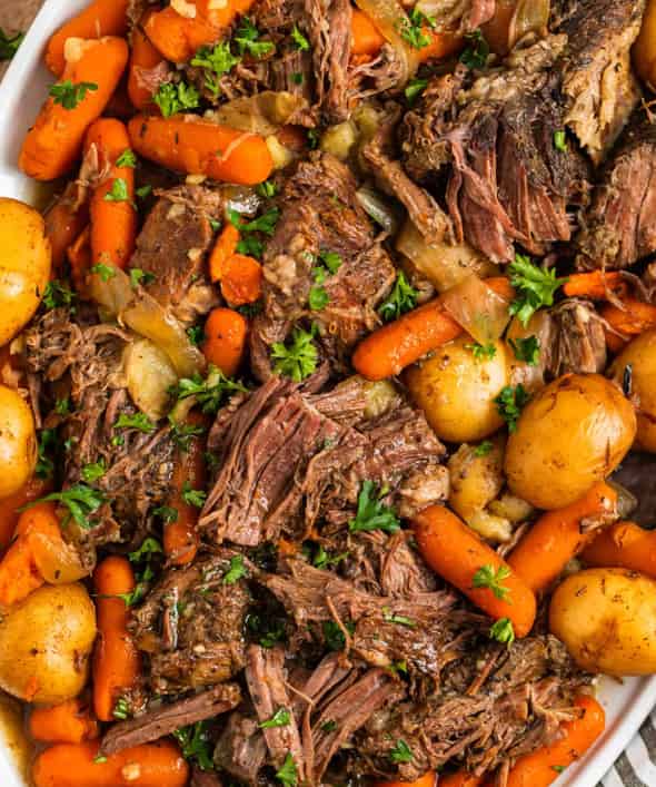 tender beef roast slow cooker dinner with carrots, potatoes, and rich gravy