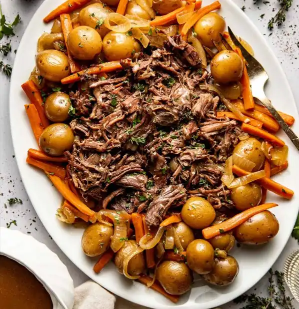 tender beef roast slow cooker dinner with carrots, potatoes, and rich gravy