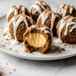 Macro close-up of pumpkin cheesecake ball showing creamy inside and crumb coating