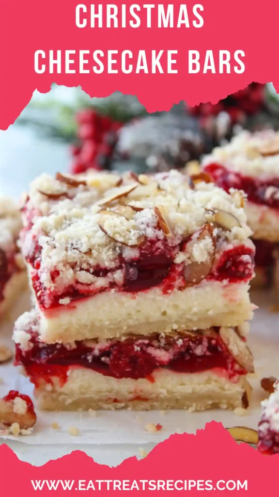 Modern Christmas cheesecake bars with vibrant cranberry swirl on white marble