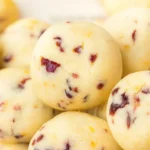 Christmas cranberry orange sandies balls on white marble
