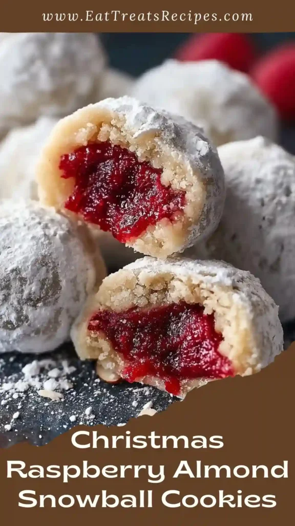 Christmas Raspberry Almond Snowball Cookies with raspberry filling and powdered sugar