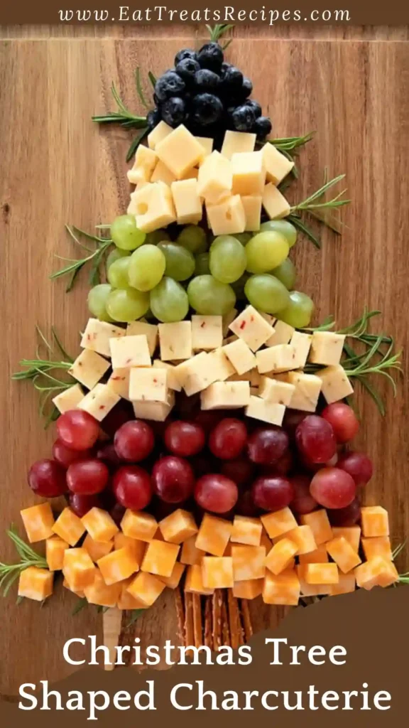 Christmas tree shaped charcuterie board with cheese cubes and fruit