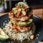 Honey lime chicken and avocado rice stack on marble