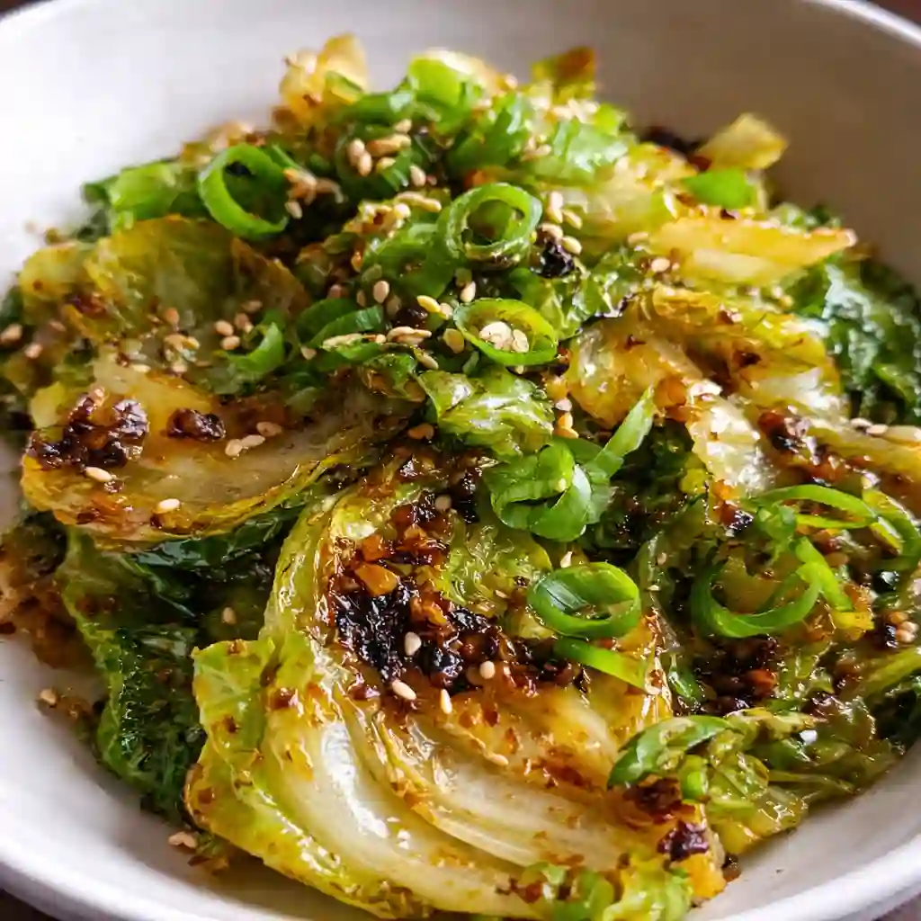 Asian cabbage stir fry with ginger and garlic served hot in a skillet