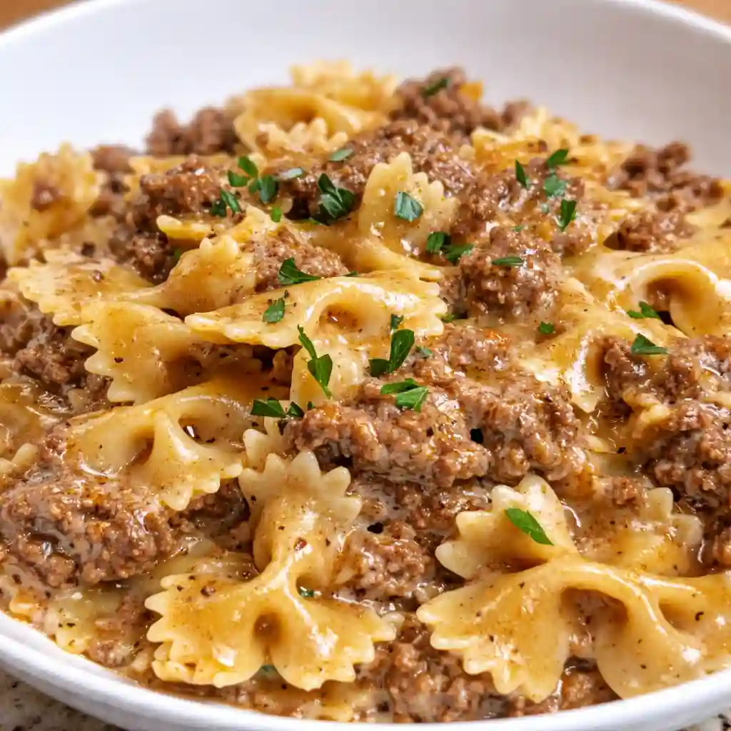 Creamy Parmesan Garlic Beef Bowtie Pasta served warm in a cozy dinner bowl