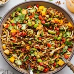 Chicken crispy rice salad in white bowl with golden crispy rice