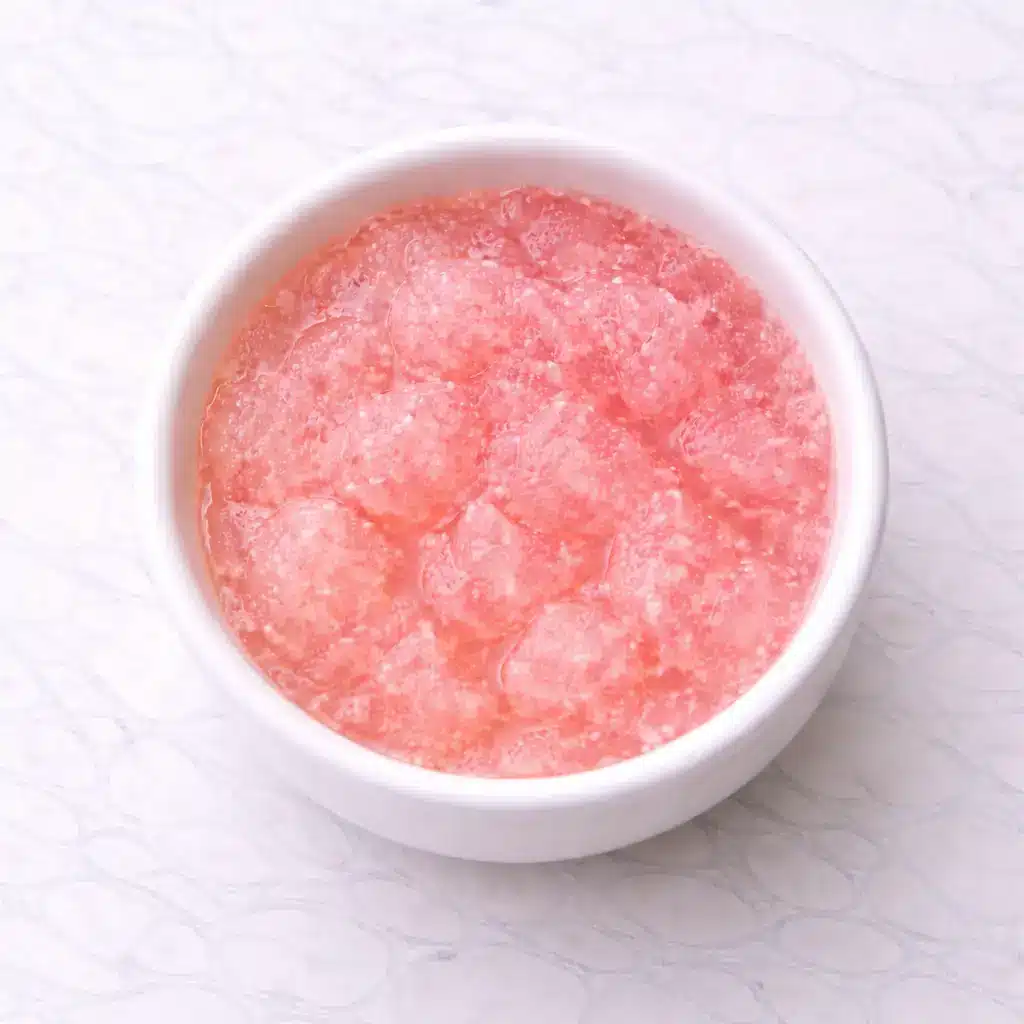 Gelatin Drink Recipe in clear glass mug on white marble surface, simple 3 ingredient gelatin trick drink