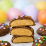 Peanut Butter Eggs coated in chocolate on white marble background