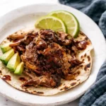 Slow Cooker Carnitas Recipe with crispy shredded pork and soft tortillas