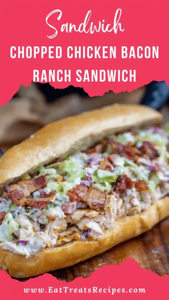 toasted chopped chicken bacon ranch sandwich cut in half showing creamy filling on marble surface