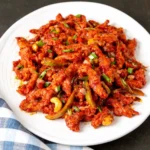 Dragon Chicken served with glossy spicy sauce and peppers