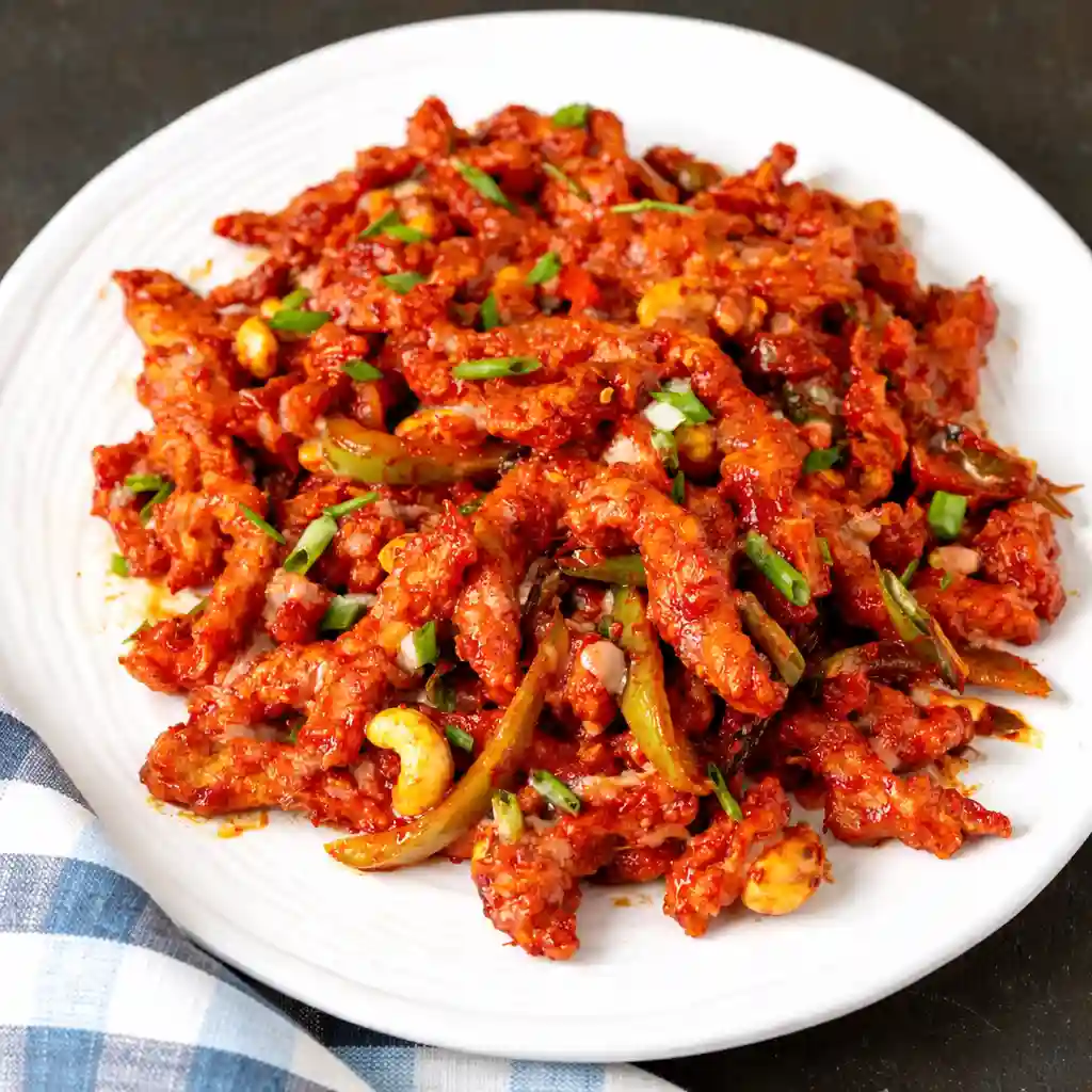 Dragon Chicken served with glossy spicy sauce and peppers