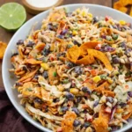 Frito Cowboy Cabbage Recipe served warm in skillet with melted cheddar and crunchy Fritos