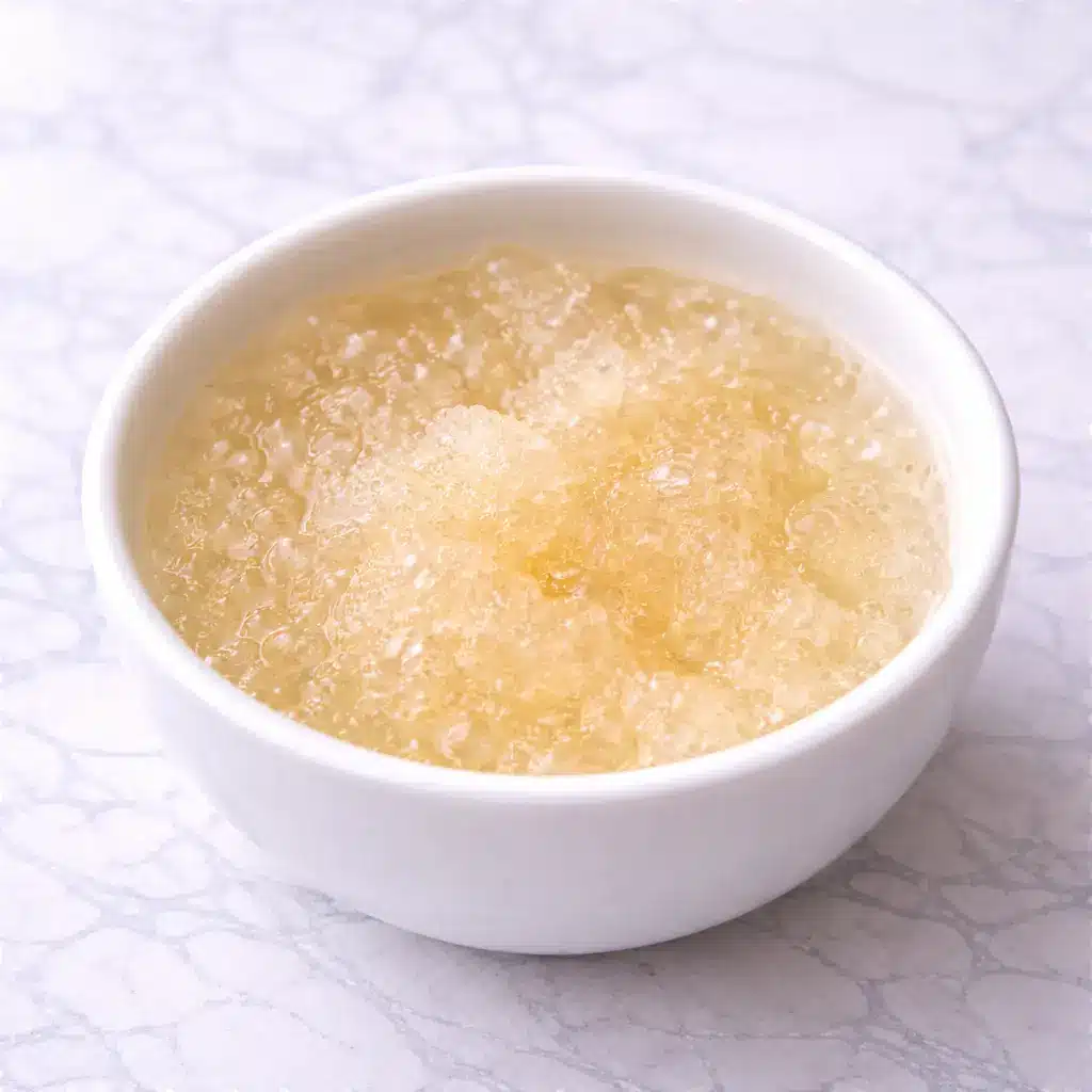 Kelly Clarkson Jello Recipe served in clear glass bowl on white marble background