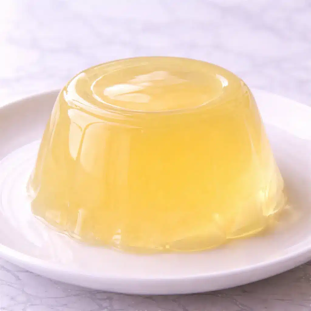 Kelly Clarkson Jello Recipe served in clear glass bowl on white marble background