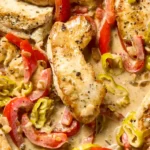 Creamy pepperoncini chicken served in white bowl with parsley garnish