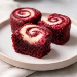 Serving red velvet cheesecake brownie bites on white plate with elegant presentation