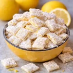 Zesty lemonade puppy chow recipe snack in white bowl on marble background