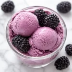 blackberry Greek frozen yogurt in bowl with fresh blackberries
