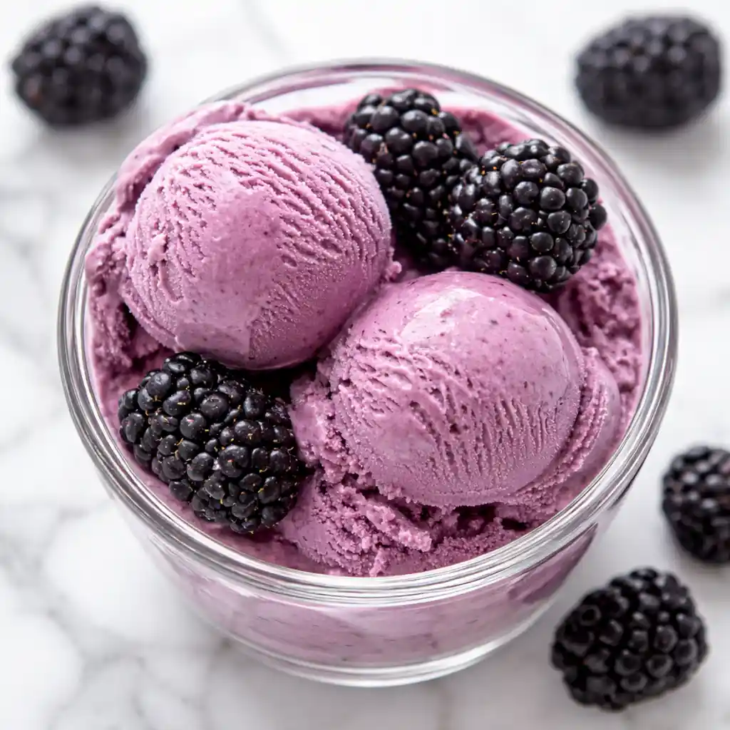 blackberry Greek frozen yogurt in bowl with fresh blackberries