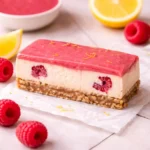 lemon raspberry cheesecake bars with shortbread crust and raspberry swirl
