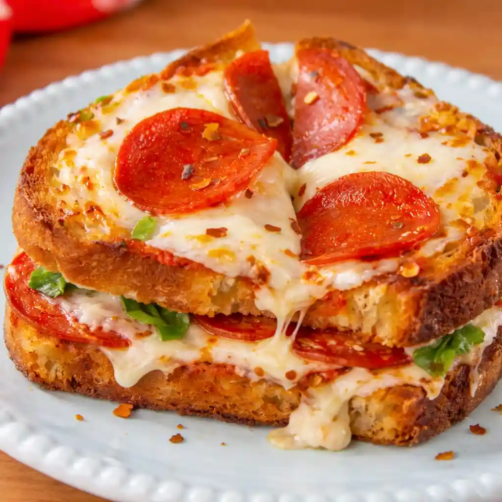 Pizza grilled cheese sandwich with melted mozzarella and pepperoni