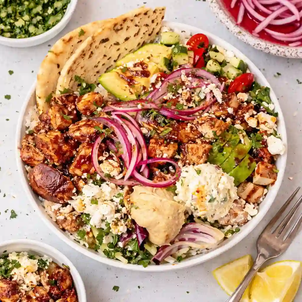 CAVA Harissa Honey Chicken copycat bowl with rice, avocado, feta and spicy honey harissa sauce